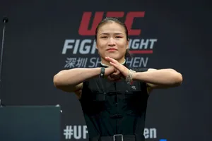 Zhang Weili Displaying Respect In Martial Arts With A Traditional Bowing Hand Gesture. Wallpaper