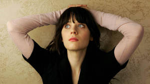 Zooey Deschanel In Black And Pink Sweater Wallpaper