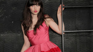 Zooey Deschanel In Pink Aesthetic Dress On Ladder Wallpaper